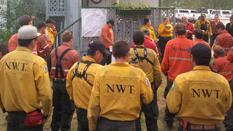 A briefing for fire crews tackling a wildfire south of Hay River in July 2015